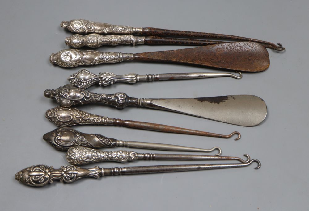 Seven assorted early 20th century silver handled button hooks and two similar shoe horns.